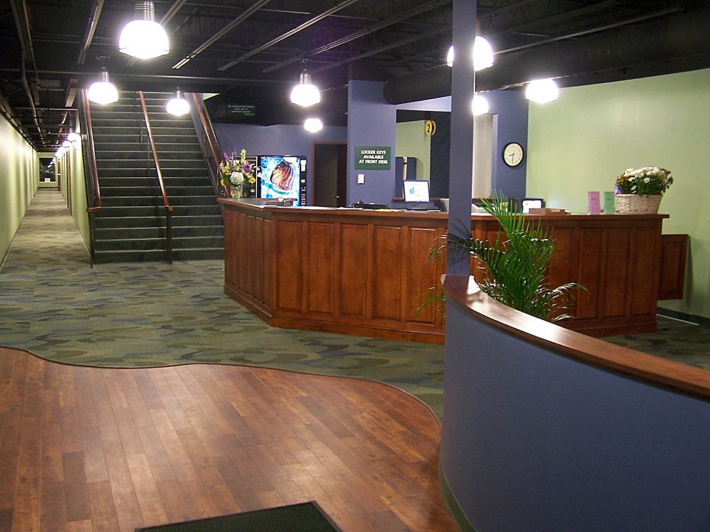 Club lobby with reception desk and staircase to the second floor